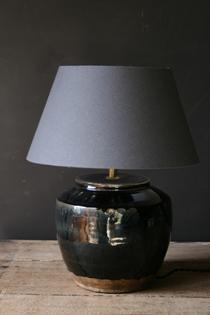 A black ceramic table lamp and grey shade