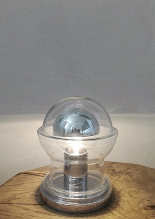A glass and chrome table lamp