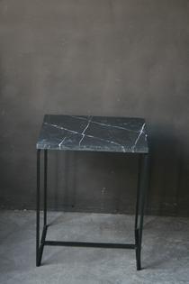 A modern steel and marble side table