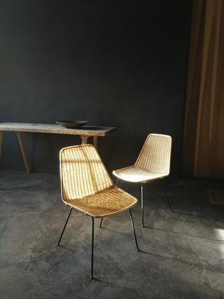 A pair of rotan and black steal seats