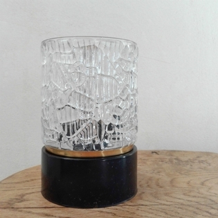 A small cuttedglass, brass and blackmetal tablelamp
