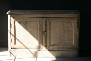 A stained oak buffet with two doors