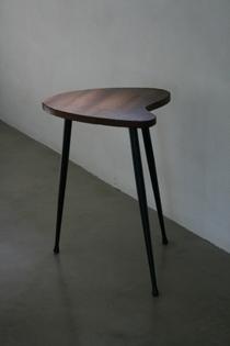 A wooden tripod side-table on metal legs.