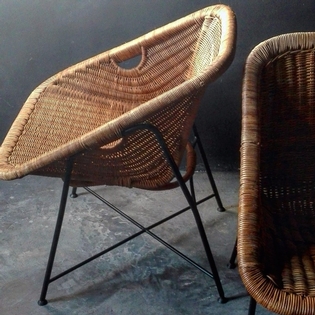 Pair of rotan and black metal armchairs, French