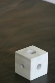 White marble cube with different sizes holes